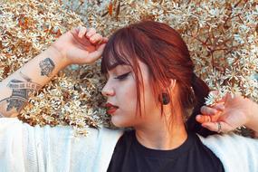 redhead woman with tottooed hand