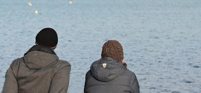 Man and Woman in front of water at winter