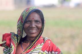 Portrait of a smiling woman, in colorful clothing in Odisha, India