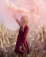 young woman with pink smoke