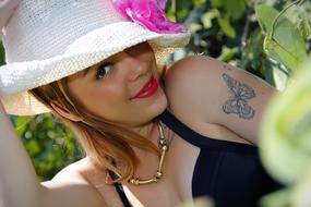woman in summer hat outdoors close up