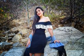 woman in nice dress posing on the stone