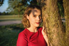 Portrait Red dress girl tree