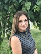 photo of a girl with long hair in a striped T-shirt
