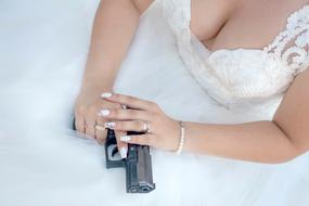 Gun in Hand of bride