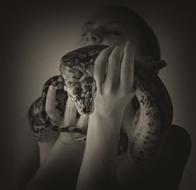 Black and white portrait of the woman, with the beautiful snake