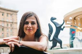 beautiful girl posing on a city street on a blurred background