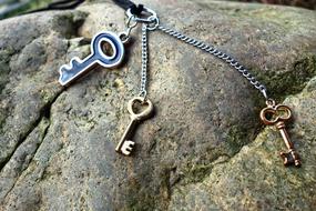 Close-up of the colorful and beautiful, shiny keys on the necklace, on the colorful stone