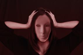 woman without face holding her head