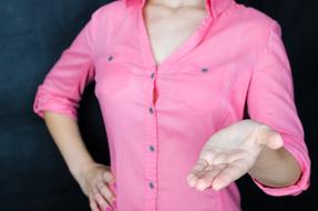 woman in pink shirt holding palm open