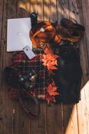Colorful clothes, notebook, phone and other stuff on the wooden surface