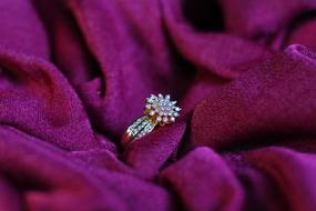 olden ring with diamonds on purple fabric