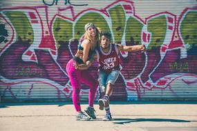 playful young boy and girl posing at Colorful Graffiti