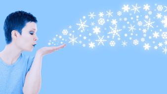 woman blowing snowflakes