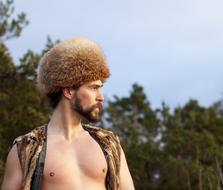 serious young man in fur hat outdoor
