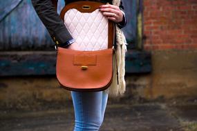 brown leather bag on her shoulder