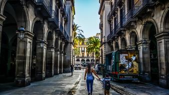 mom and son are walking in the old town in Barcelona, Spain