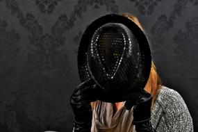 woman hiding her face with black hat