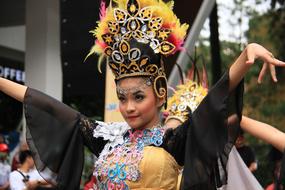 Girl, dancing Sunda, in beautiful and colorful, traditional clothes, on the festival in Indonesia