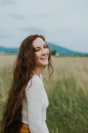 long haired brunette laughing outdoor