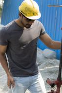 a man in a yellow helmet at a construction site