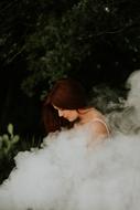 girl bowing in white smoke