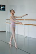 Child girl ballerina, near the railing