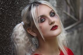 cool young Blonde girl with heart painting on cheek