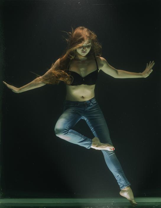 Beautiful woman with black bikini, underwater, in light