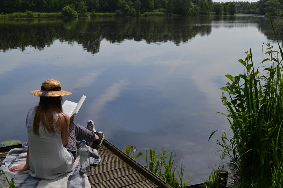 girl on the pier with a book