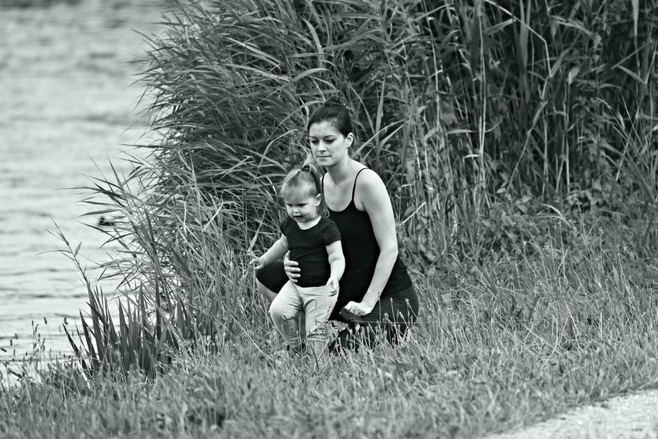 mom with baby on the river bank in black and white background