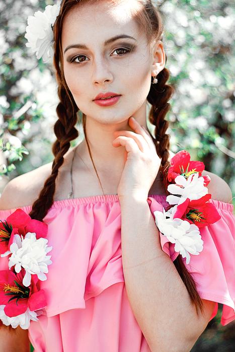 photo of a girl in a pink dress and flowers in her hair