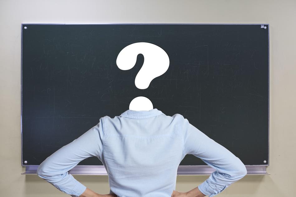 White question mark sign, on the head of a person, with the shirt, near the board