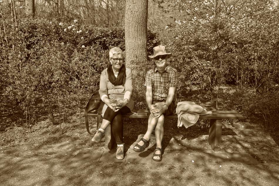 woman and man under a tree in sepia color