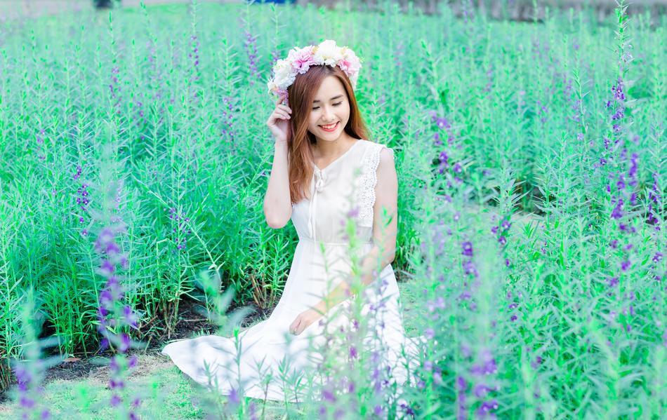 cute woman on the meadow with wreath