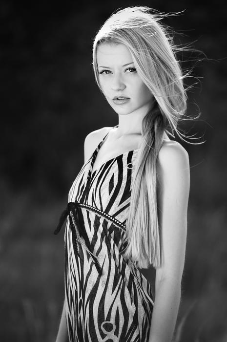 blonde posing in black and white blurred background