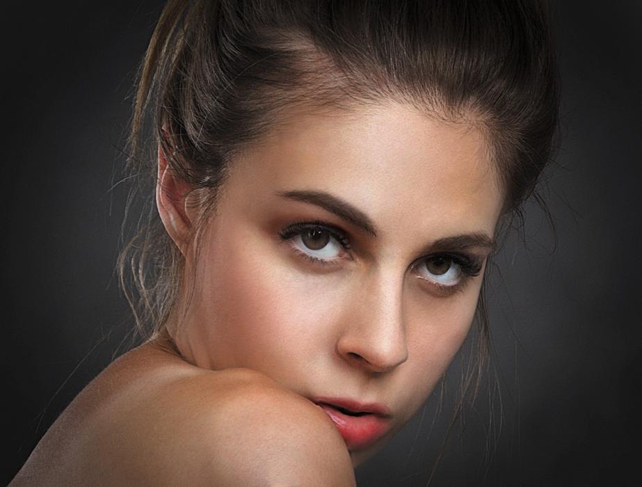 Portrait of the beautiful woman, looking out of the shoulder