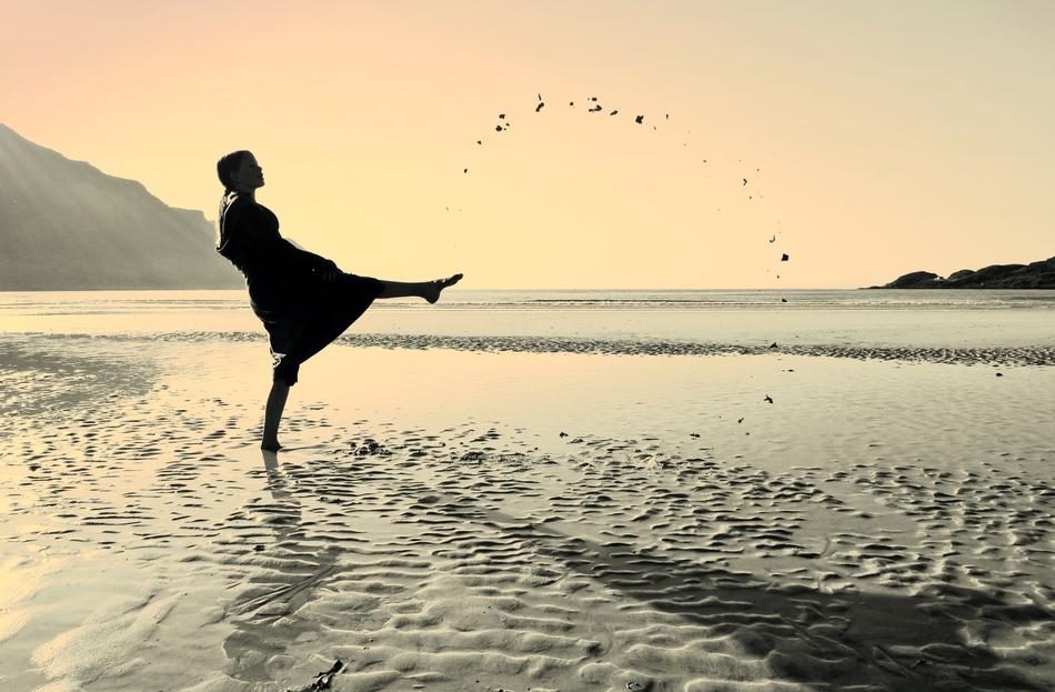 woman playing with water on the beach