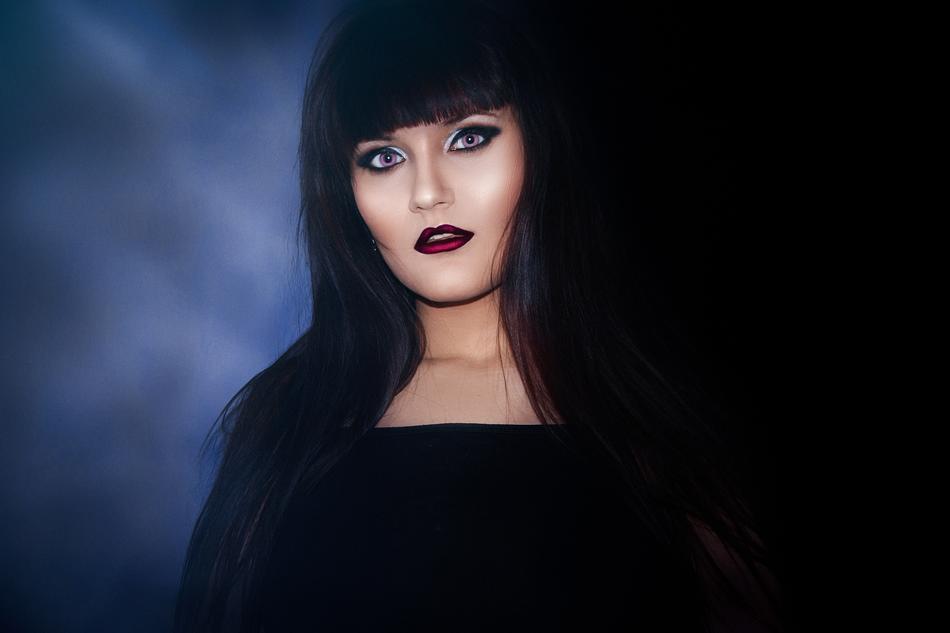 woman with black hair and impressive makeup
