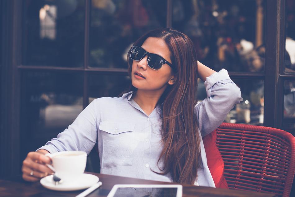 beautiful girl in black glasses in a cafe