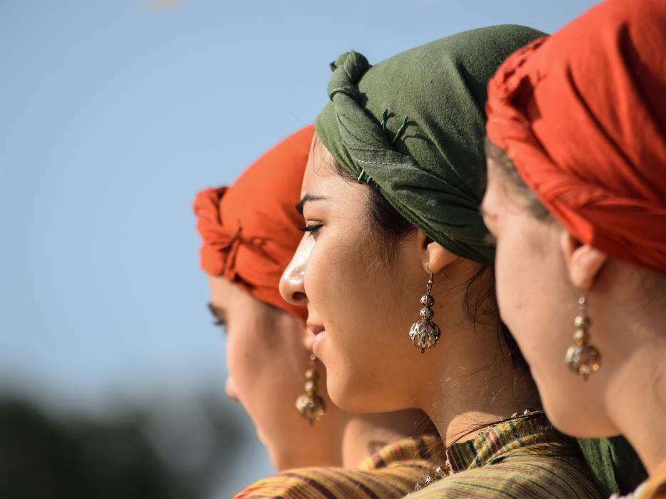 Girls with earrings and head kerchiefs in light, on Cyprus, Greece