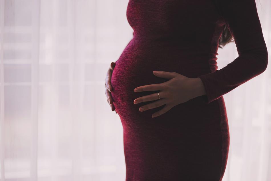 photo of a pregnant woman in a burgundy dress