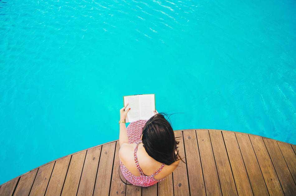 woman reading at water