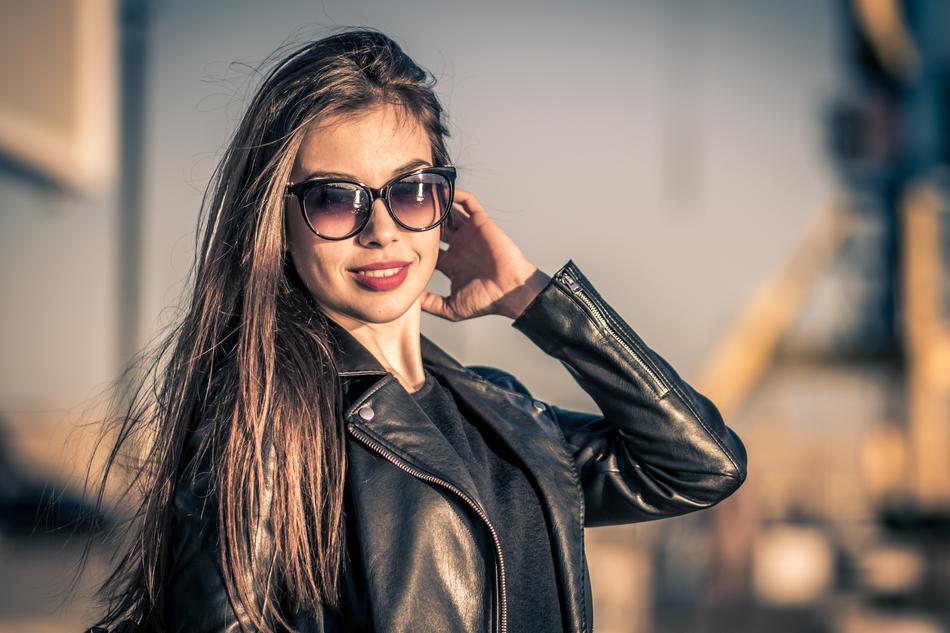Portrait of the beautiful woman, with the glasses, and make-up, in black jacket