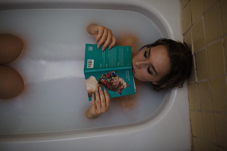 girl with a book in a bubble bath