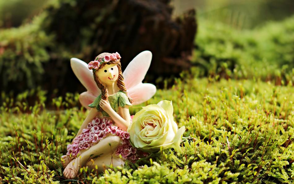 ceramic figurine of an elf on green grass in the forest