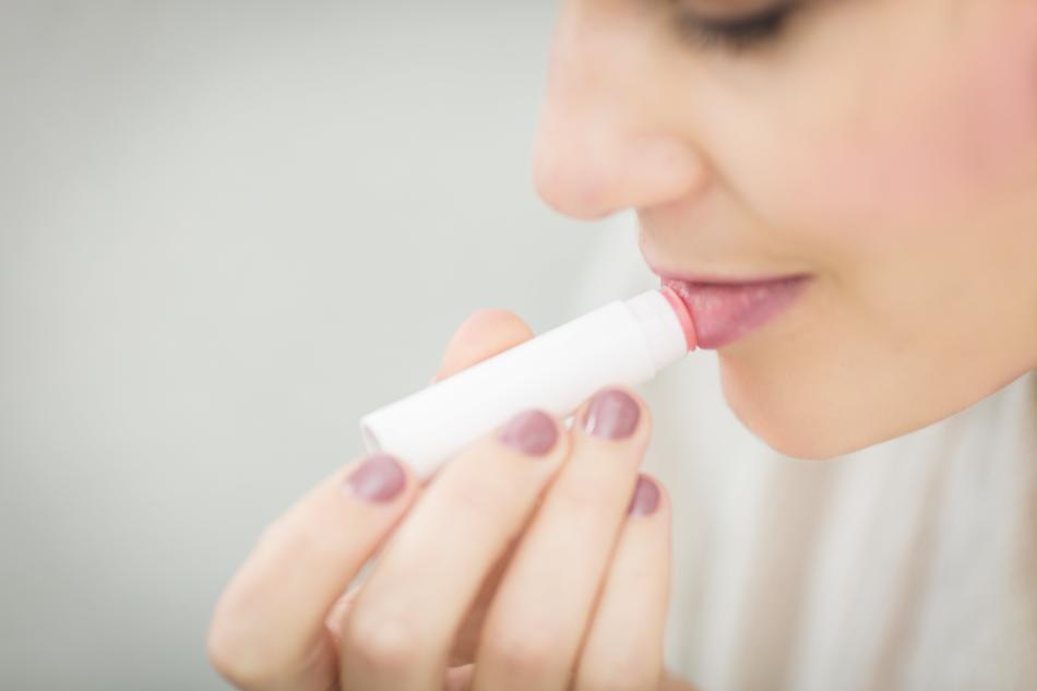 woman applying a lip balm