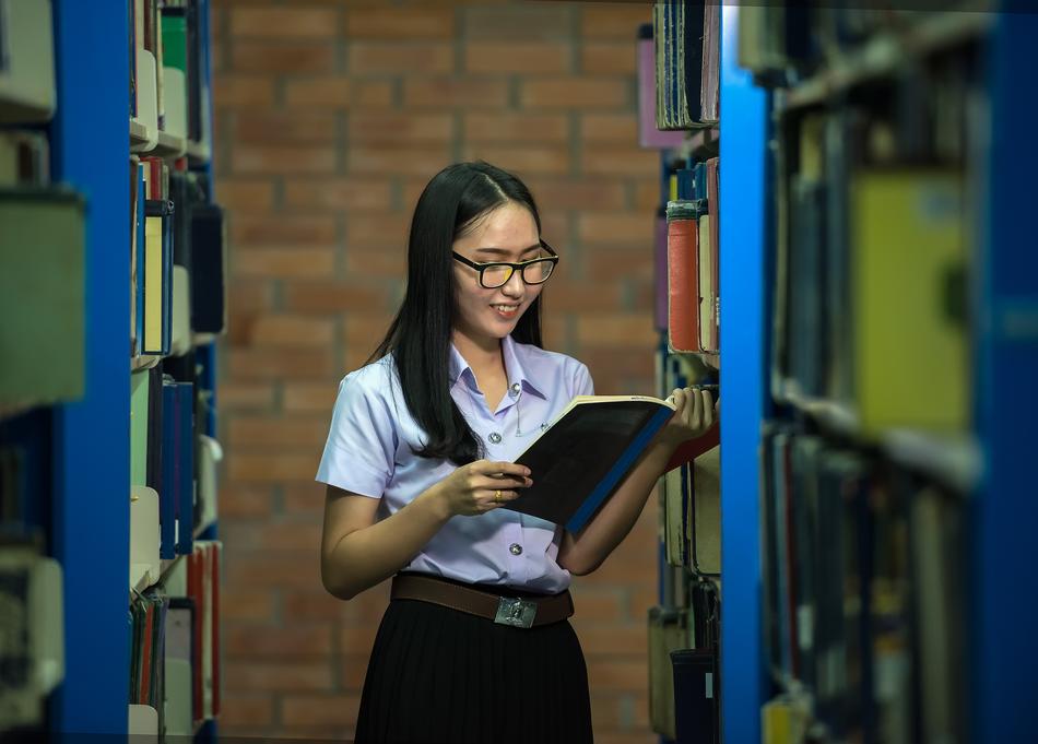 girl among the shelves in the library