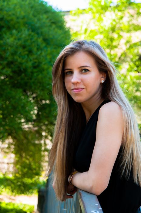 blonde with long hair on a background of green trees
