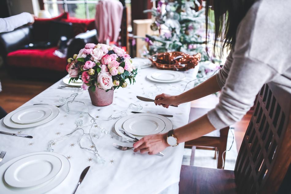 girl setting the table for christmas